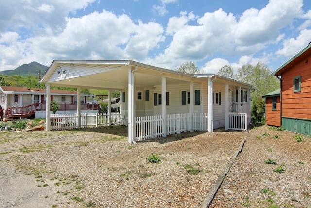 222 Pike Pt, Waynesville, NC 28785 - exterior space with driveway, fence, a mountain view, and a carport