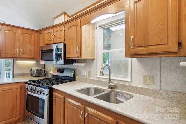 222 Pike Pt, Waynesville, NC 28785 - kitchen featuring brown cabinets, stainless steel appliances, a healthy amount of sunlight, and a sink