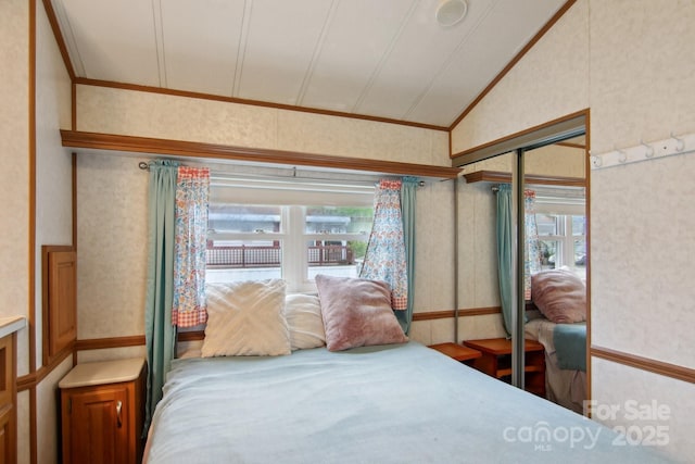 222 Pike Pt, Waynesville, NC 28785 - bedroom with crown molding, multiple windows, vaulted ceiling, and wallpapered walls