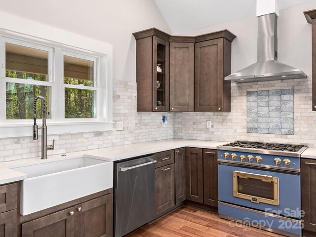 1810 Coopers Gap Rd, Mill Spring, NC 28756 - kitchen with stainless steel dishwasher, dark brown cabinetry, gas range, wall chimney exhaust hood, and a sink