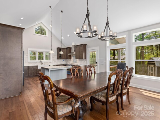 1810 Coopers Gap Rd, Mill Spring, NC 28756 - dining area with an inviting chandelier, plenty of natural light, and hardwood / wood-style floors