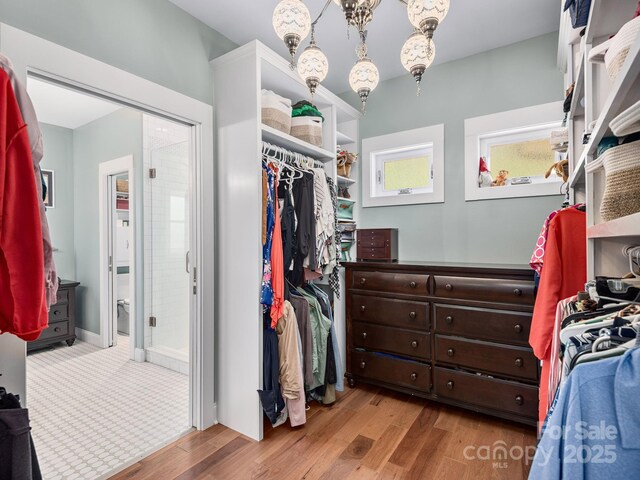 1810 Coopers Gap Rd, Mill Spring, NC 28756 - spacious closet with an inviting chandelier and wood finished floors