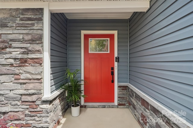 view of exterior entry featuring stone siding
