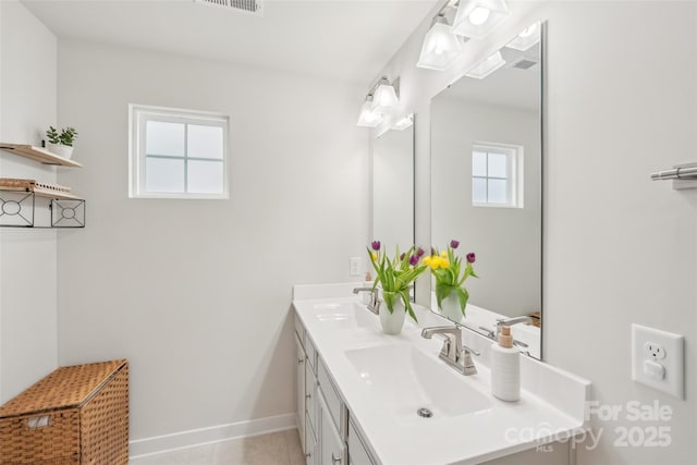 full bathroom featuring double vanity, visible vents, baseboards, and a sink