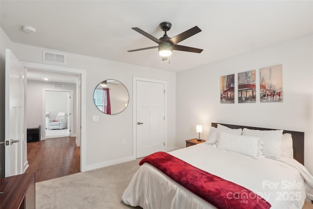 bedroom with carpet, visible vents, a ceiling fan, and baseboards