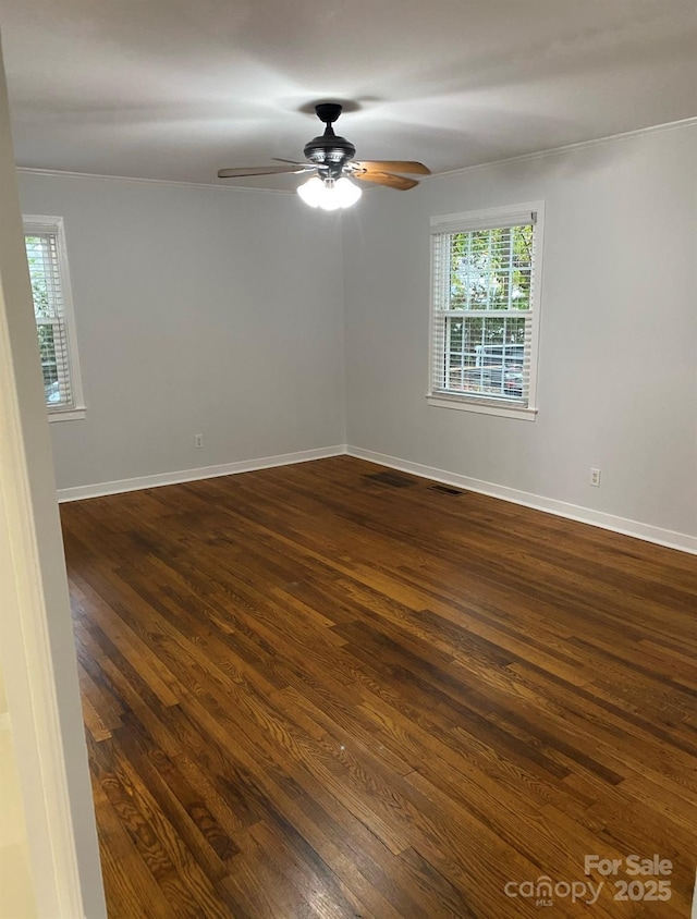4100 Howie Cir, Charlotte, NC 28205 - spare room featuring dark wood-style flooring, a healthy amount of sunlight, ceiling fan, and baseboards