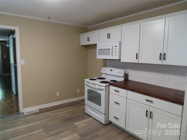 kitchen featuring tasteful backsplash, visible vents, light wood-style floors, butcher block countertops, and white appliances