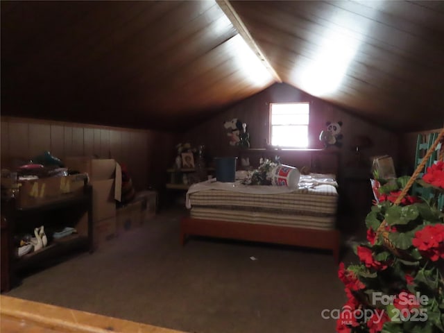 carpeted bedroom with wooden ceiling, wooden walls, and vaulted ceiling