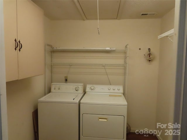 washroom featuring attic access, visible vents, laundry area, and washer and clothes dryer