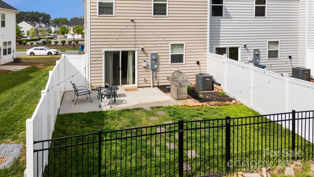 3828 Yorkshire Pl, Terrell, NC 28682 - rear view of house with central air condition unit, a lawn, a fenced backyard, and a patio
