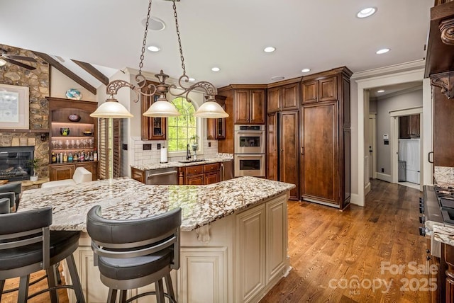 4600 Spicewood Dr, Charlotte, NC 28227 - kitchen with a sink, appliances with stainless steel finishes, a fireplace, and light stone counters