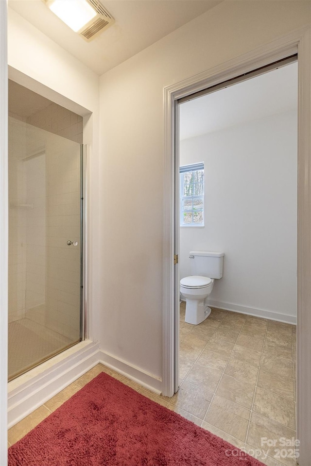661 Old Chestnut Mountain Rd, Newland, NC 28657 - full bathroom featuring a shower stall, toilet, tile patterned flooring, and baseboards
