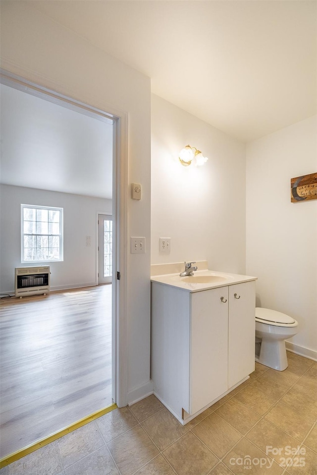 661 Old Chestnut Mountain Rd, Newland, NC 28657 - bathroom featuring heating unit, toilet, vanity, baseboards, and tile patterned floors