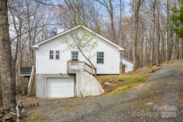 661 Old Chestnut Mountain Rd, Newland, NC 28657 - view of front facade with stairway, a chimney, driveway, and an attached garage