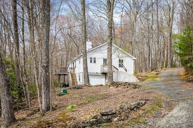 661 Old Chestnut Mountain Rd, Newland, NC 28657 - view of side of property featuring a chimney, a garage, a wooden deck, and a wooded view