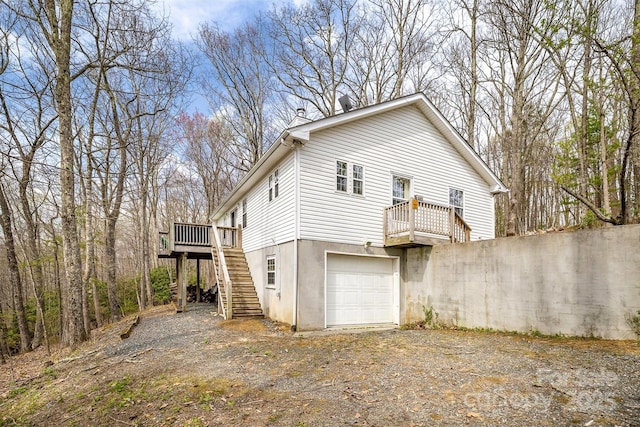 661 Old Chestnut Mountain Rd, Newland, NC 28657 - view of side of home with stairway, a wooden deck, dirt driveway, and a garage