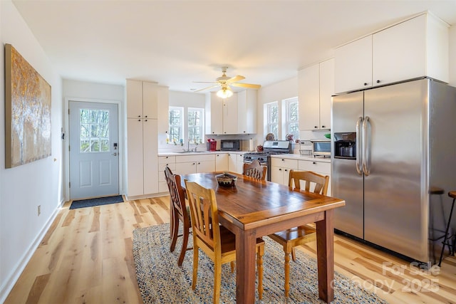 661 Old Chestnut Mountain Rd, Newland, NC 28657 - dining room featuring healthy amount of natural light, light wood-style flooring, a ceiling fan, and baseboards