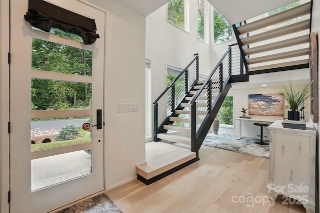9305 Valley Rd, Charlotte, NC 28270 - foyer entrance featuring baseboards, stairway, a wealth of natural light, and light wood-style floors