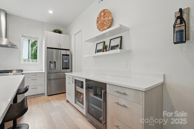 9305 Valley Rd, Charlotte, NC 28270 - kitchen featuring beverage cooler, light countertops, light wood-type flooring, stainless steel refrigerator with ice dispenser, and modern cabinets
