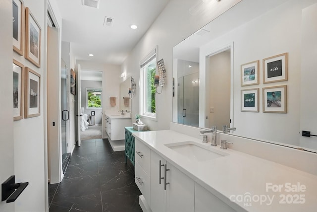 9305 Valley Rd, Charlotte, NC 28270 - bathroom featuring a stall shower, recessed lighting, a sink, and two vanities