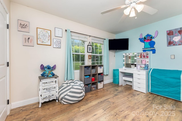 home office featuring vaulted ceiling, baseboards, a ceiling fan, and wood finished floors