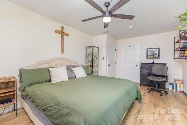 bedroom with visible vents, ceiling fan, and wood finished floors