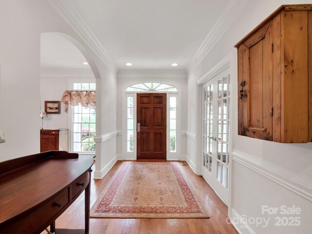 7716 Seton House Ln, Charlotte, NC 28277 - entryway with light wood-type flooring, crown molding, arched walkways, french doors, and recessed lighting