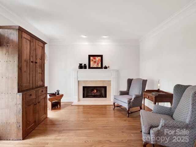 7716 Seton House Ln, Charlotte, NC 28277 - living area featuring ornamental molding, light wood finished floors, a fireplace with flush hearth, and recessed lighting