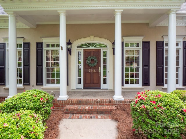 7716 Seton House Ln, Charlotte, NC 28277 - entrance to property featuring covered porch and stucco siding