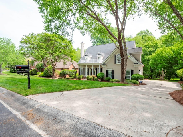 7716 Seton House Ln, Charlotte, NC 28277 - view of front facade with a balcony, stucco siding, a chimney, and a front yard