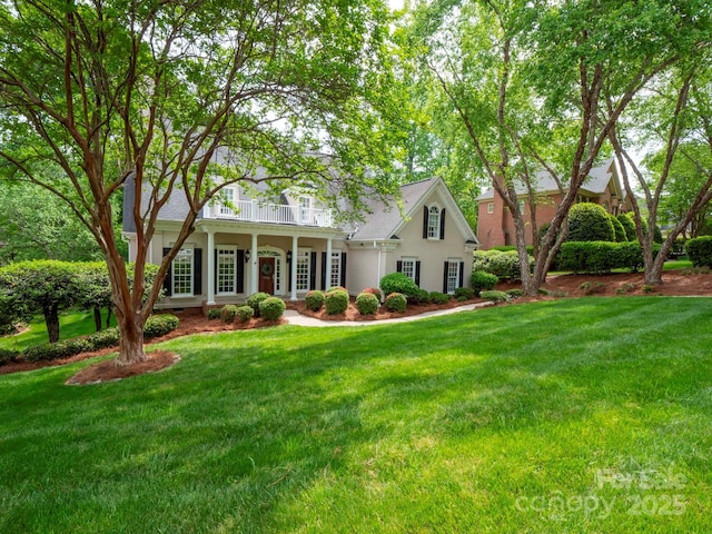 7716 Seton House Ln, Charlotte, NC 28277 - view of front of house with a balcony, a front yard, covered porch, and stucco siding