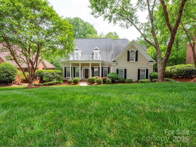7716 Seton House Ln, Charlotte, NC 28277 - cape cod home featuring a balcony, a front yard, stucco siding, and a porch