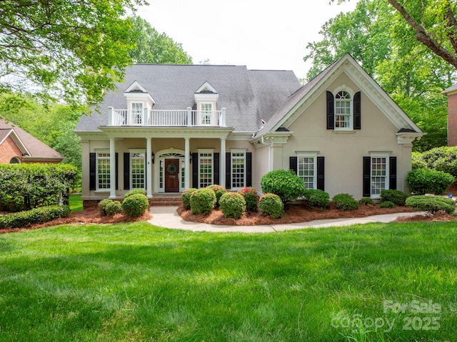 7716 Seton House Ln, Charlotte, NC 28277 - view of front of house with a balcony, a front yard, stucco siding, a shingled roof, and covered porch