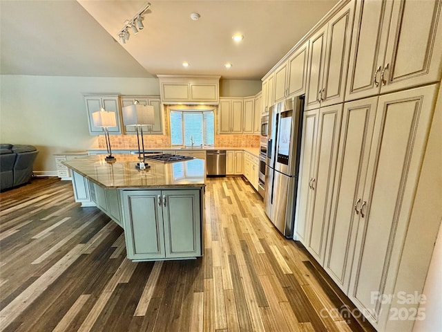 255 Charlotte Ann Ln, Hickory, NC 28601 - kitchen with a sink, appliances with stainless steel finishes, a center island, light wood finished floors, and backsplash