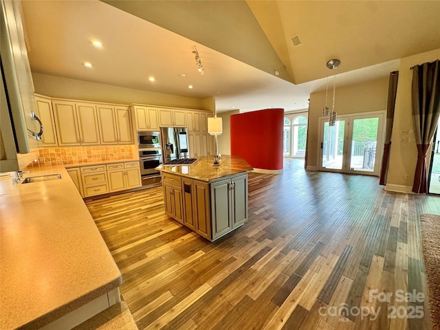 255 Charlotte Ann Ln, Hickory, NC 28601 - kitchen featuring light countertops, decorative backsplash, stainless steel appliances, and light wood-type flooring
