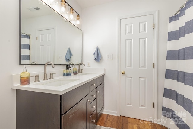 5804 Crosswinds Ct, Indian Trail, NC 28079 - bathroom featuring wood finished floors, double vanity, and baseboards