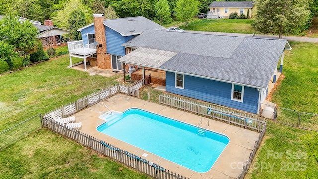 view of swimming pool featuring a patio, a fenced in pool, a fenced backyard, and a yard