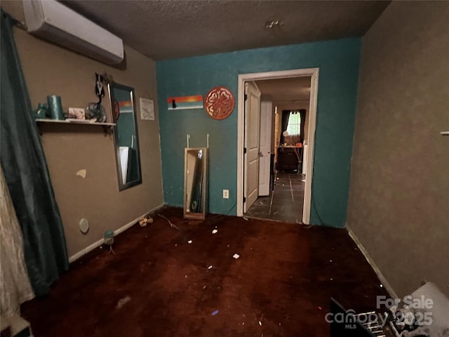 380 Echo Hill Dr, Green Mountain, NC 28740 - unfurnished bedroom featuring a wall mounted AC and a textured ceiling