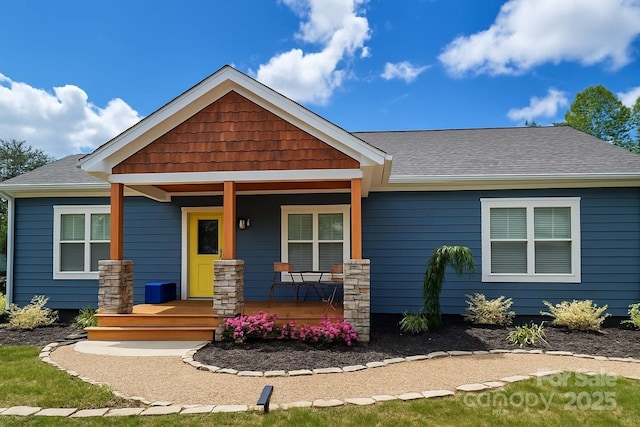 craftsman-style house with roof with shingles and covered porch