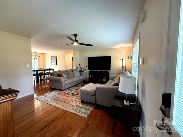 living room with baseboards, a ceiling fan, and wood finished floors