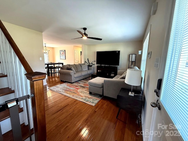 living room featuring stairway, a ceiling fan, and wood finished floors