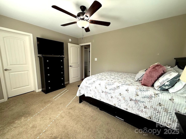 bedroom featuring ceiling fan and light carpet