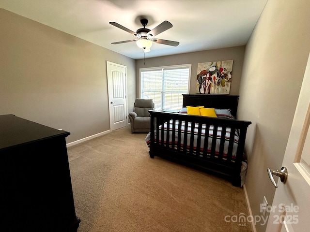carpeted bedroom featuring baseboards and a ceiling fan