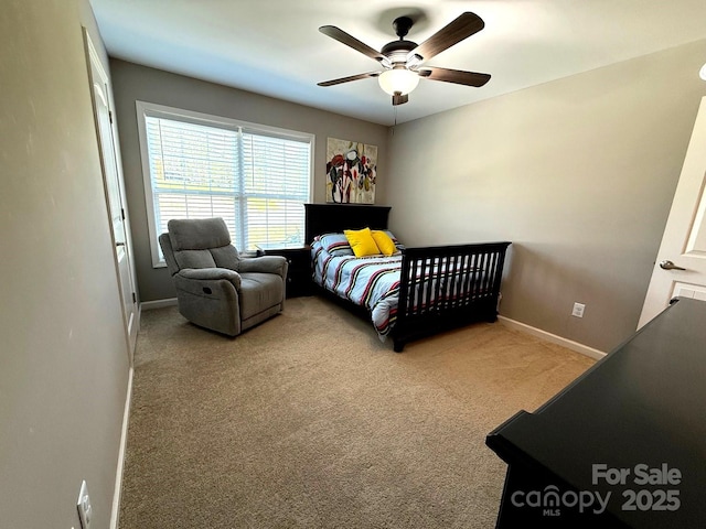 carpeted bedroom with a ceiling fan and baseboards