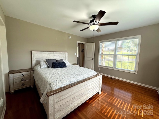 bedroom featuring dark wood-style flooring, baseboards, and a ceiling fan