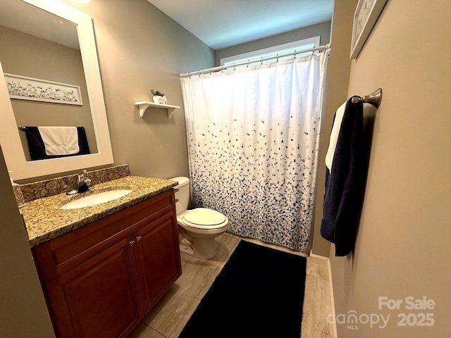 bathroom featuring vanity, toilet, and a shower with curtain