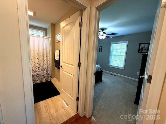 hallway featuring baseboards