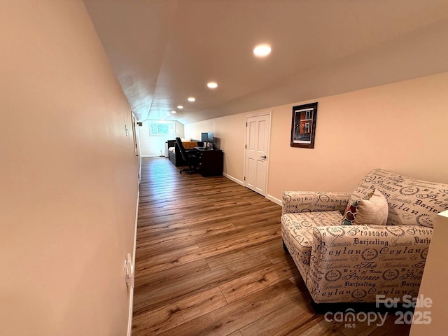 living area with baseboards, vaulted ceiling, recessed lighting, and hardwood / wood-style floors