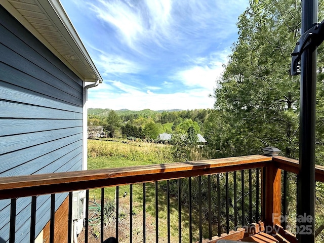 wooden deck featuring a forest view