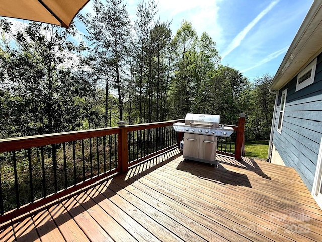 wooden terrace featuring area for grilling